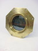 A brass octagonal port hole by Atkey and Son, Cowes: stamped as per title to frame, 28.5cm wide. .