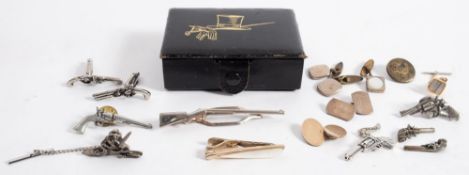 A pair of flintlock pistol cufflinks:, together with a group of pistol and firearms lapel badges,