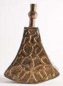 A Moroccan brass powder flask: of triangular form with scroll decorated front,