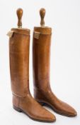 A pair of brown leather riding boots and trees by Peal & Co, London:,