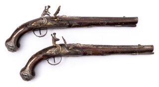 A pair of late 18th /early 19th century Turkish silver and gold decorated flintlock pistols:,