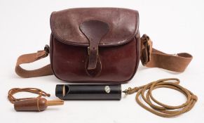 A brown leather cartridge bag together with an Acme 'Dove & Pigeon call' and a wooden duck call:.