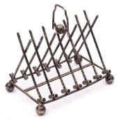 A plated six-division toast rack: of arched outline, in the form of crossed croquet mallets,