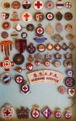 A collection of World War II lapel badges relating to the Red Cross,