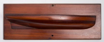 A mahogany half block model of a gig:, in laminated sections on a plain plinth, 13.