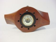 A mahogany propeller boss inset aneroid barometer:,