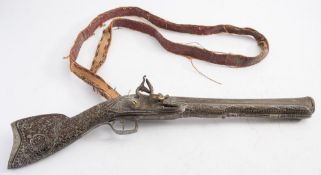 A Balkan-decorated Turkish flintlock 'knee' blunderbuss:, the 12 1/2 inch barrel with flared muzzle,