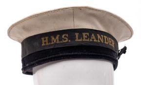 A Royal Navy regulation rating hat with HMS Leander tally:.