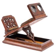 A Victorian walnut stereo graphoscope:, with four inch magnifying lens and drop in stereo lenses,