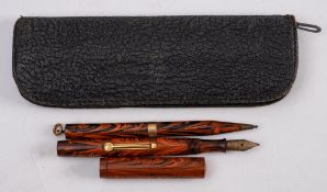 A Waterman's Ideal red marbled fountain pen and propelling pencil:,