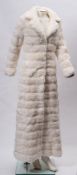 A collection of vintage clothing and textiles: including white faux fur full length coat and a