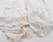 A collection of cutwork linen including petticoats, bloomers, a christening gown etc:,