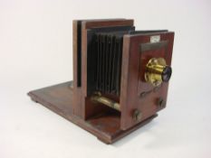 A mahogany and brass glass plate 'Optimus' camera frame by Perkins, Son & Raiment':,
