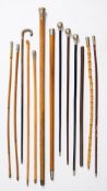 A group of eight silver plate mounted regimental swagger sticks: together with three other swagger