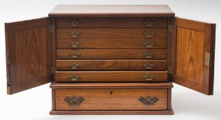 An Edwardian oak collector's cabinet:,