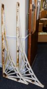 A pair of large cast iron wall brackets: of L-shaped outline with fan spandrel decoration,