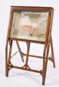 An Edwardian mahogany and brass mounted map display cabinet: of angled form with a hinged top and