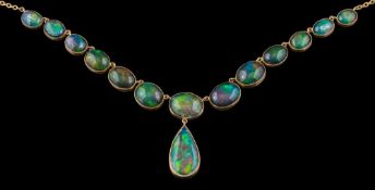 An opal mounted necklace: of graduated oval opal doublets and opals with black painted backs and
