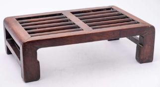 A Chinese huanghuali footstool: of rectangular form with rounded slats, 44 x 30cm.