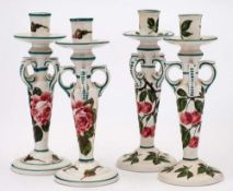 Two pairs of Wemyss Kintore pottery candlesticks: one pair decorated with pink cabbage roses and