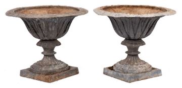 A pair of lead garden urns: of campana form,