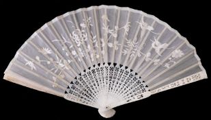 A Chinese ivory brise fan: carved to one side with figures in a pagoda landscape, 19cm.