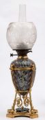 A Doulton Lambeth stoneware oil lamp: the base and reservoir decorated by Mark V.