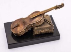 An Austrian bronze novelty match striker: in the form of a violin and bow resting on a tasselled