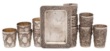 A set of six Chinese silver beakers, unmarked: with floral and insect decoration, 5cm.