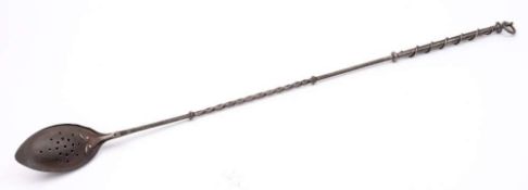 A steel chestnut roaster: the long handle part twisted and the grip entwined with a tendril,