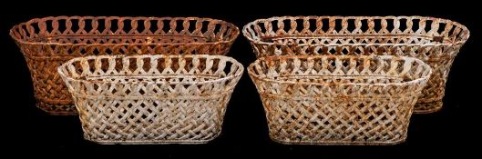 A pair of cast iron garden baskets: of oval outline with interwoven sides and hooped border, 88cm.