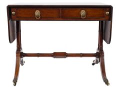 A Regency mahogany sofa table:, the hinged top with rounded corners and a reeded edge,