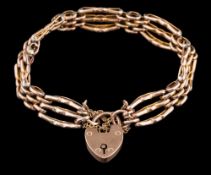 A 9ct gold three-bar, gate-link bracelet: with padlock clasp approximately 12gms gross weight.