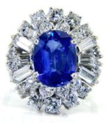 A sapphire and diamond cocktail cluster ring: circa 1950 with central oval blue sapphire 10.