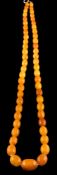 A graduated amber bead single-string necklace: with 55 oblong beads graduating from 9mm long to