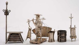 A Chinese silver miniature model of a market seller:, his wares hung from a yoke on his shoulder,