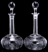 A pair of 19th century cut glass shaft and globe decanters and stoppers: of conventual form with