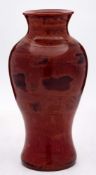 A Chinese Beijing 'Realgar' glass vase: of baluster form, the marbled red,