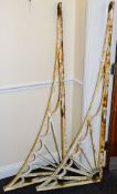 A pair of large cast iron wall brackets: of L-shaped outline with fan spandrel decoration,
