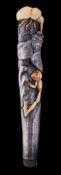 A Japanese ivory and silver parasol handle: decorated with a stag beetle and tree frog attacking a