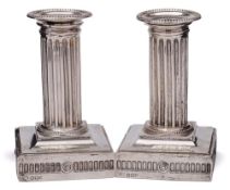 A pair of Victorian silver column candlesticks, maker Goldsmiths & Silversmiths Co, Sheffield,
