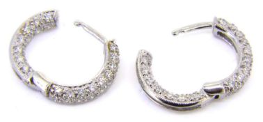 A pair of 18ct white gold and diamond hoop earrings: pave-set throughout with brilliant-cut