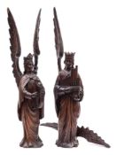 A pair of 19th Century Continental carved oak figures of angels: each with outstretched wings,