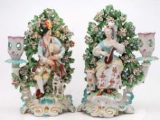 A pair of Derby porcelain figural candlesticks: modelled as a shepherd and companion,