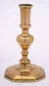 A late 17th/early 18th Century French brass candlestick: with plain cylindrical nozzle on a