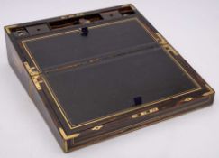 A Victorian coromandel and brass bound and strung writing box: the hinged lid enclosing a leather