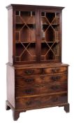 A George III mahogany bookcase on chest:, the upper part with a moulded cornice,