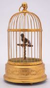 A 20th Century French musical bird in gilded cage: the feathered bird on a T-shaped perch,
