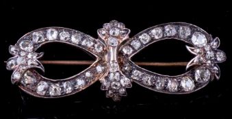 A diamond mounted bow brooch: with loops of graduated old brilliant-cut diamonds estimated to weigh