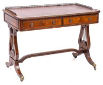 A mahogany rectangular writing table in the Regency taste: with beaded mouldings,